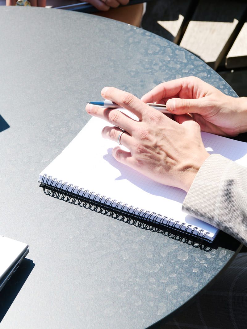Woman writing in a notebook with pen