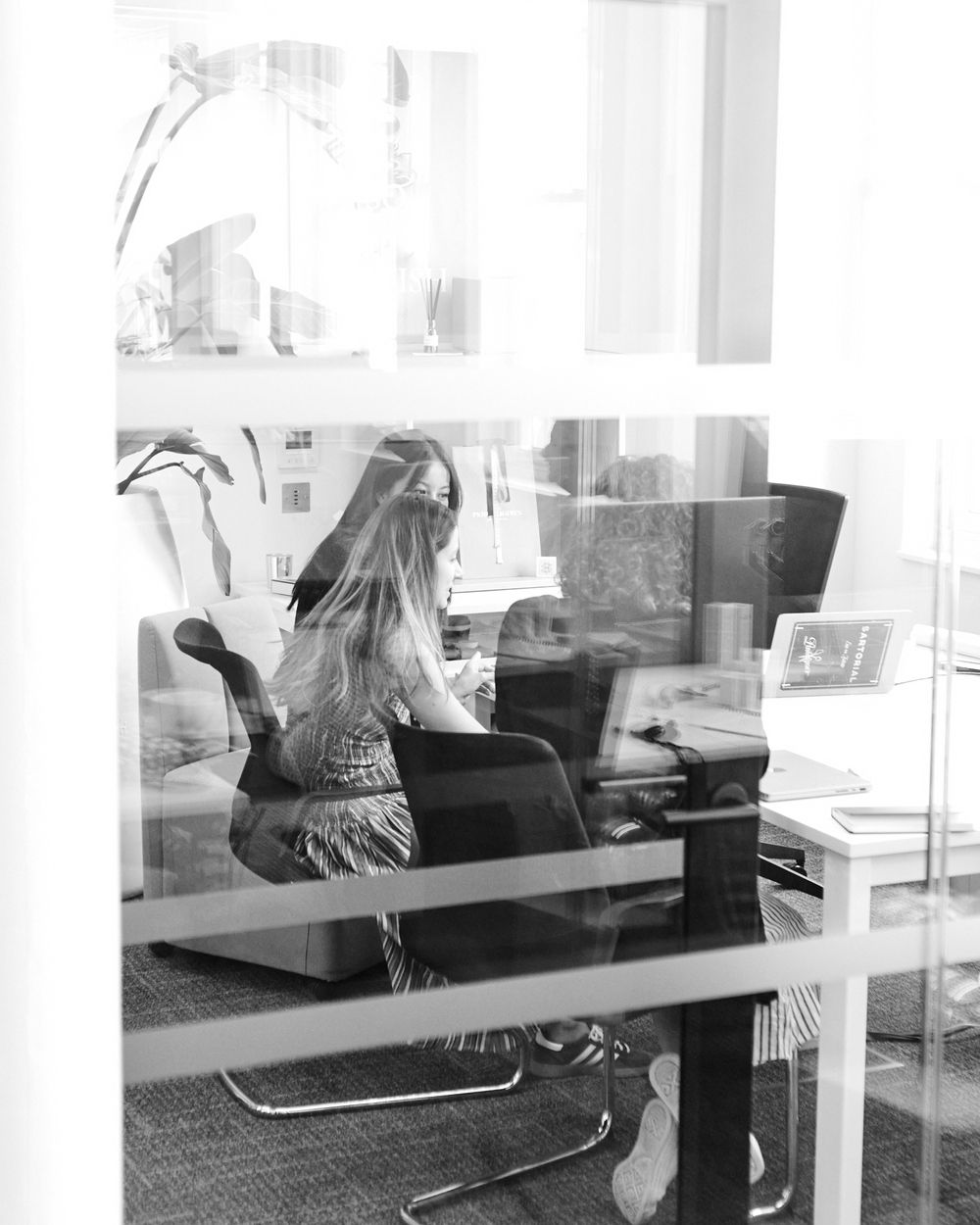 Example of young professionals collaborating on how to get a career in fashion within a modern workplace